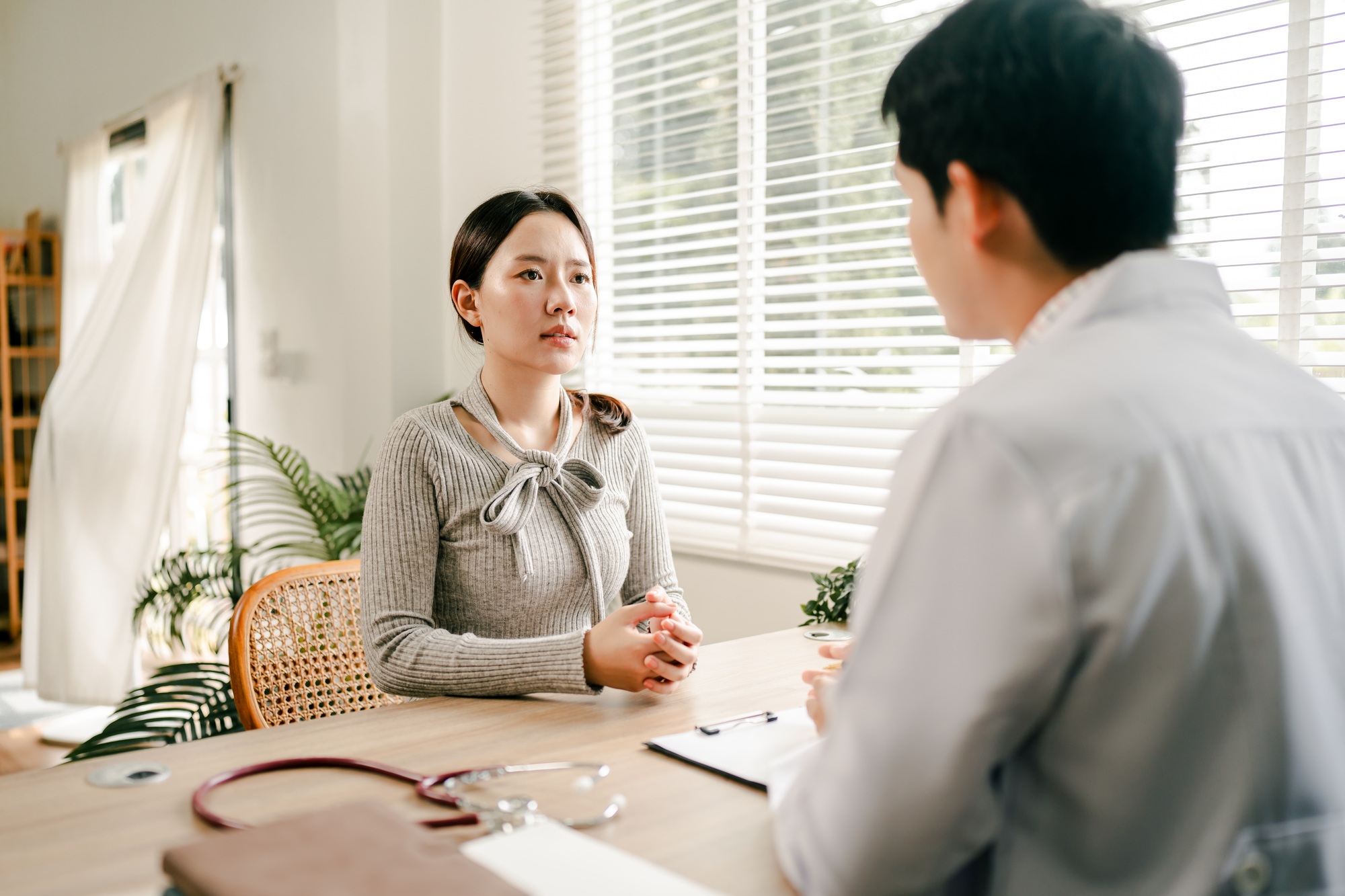 Doctor talking to patient and filling patient history, examination, treatment, medical