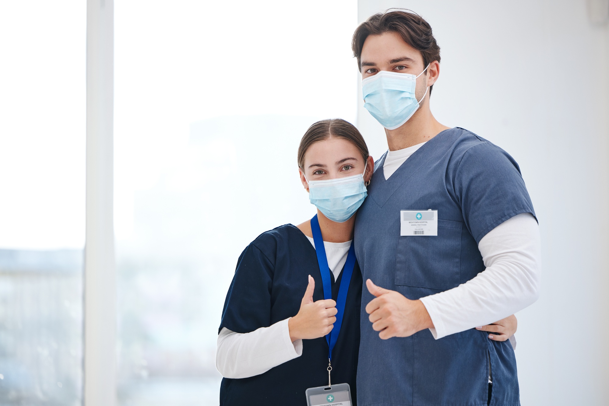 Portrait, doctors and people hug, thumbs up or vote opinion for medical service, medical agreement